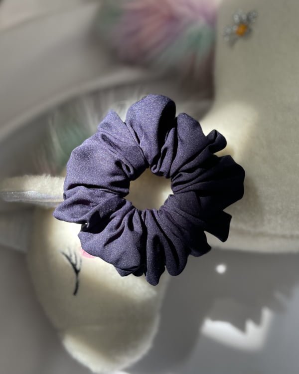 Stylish Navy Arnol scrunchies with classic navy tones, perfect for adding an elegant and sophisticated touch to your hairstyles, complementing any outfit with timeless charm.