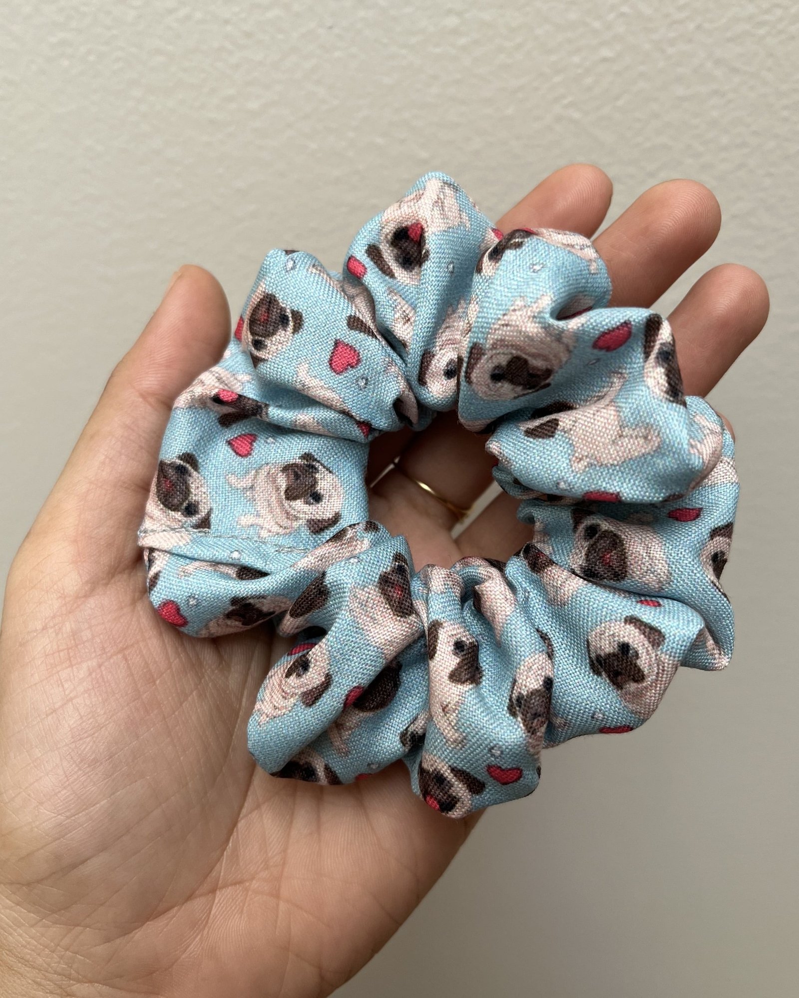 Chic Pug scrunchies, perfect for adding a cute and trendy touch to your hairstyles, inspired by adorable pugs.